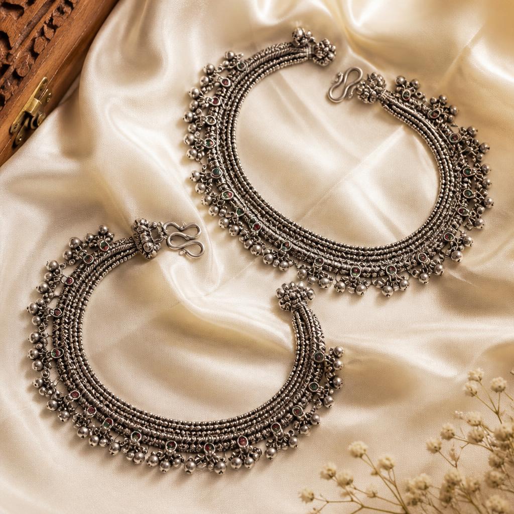 Pair of oxidised silver anklets with ghungroo bells on ivory silk